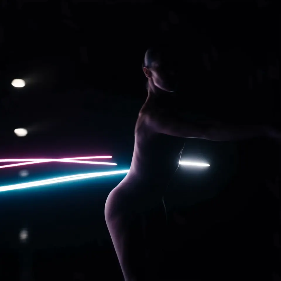 AI music visualizer video with a performer surrounded by pulsing neon waves